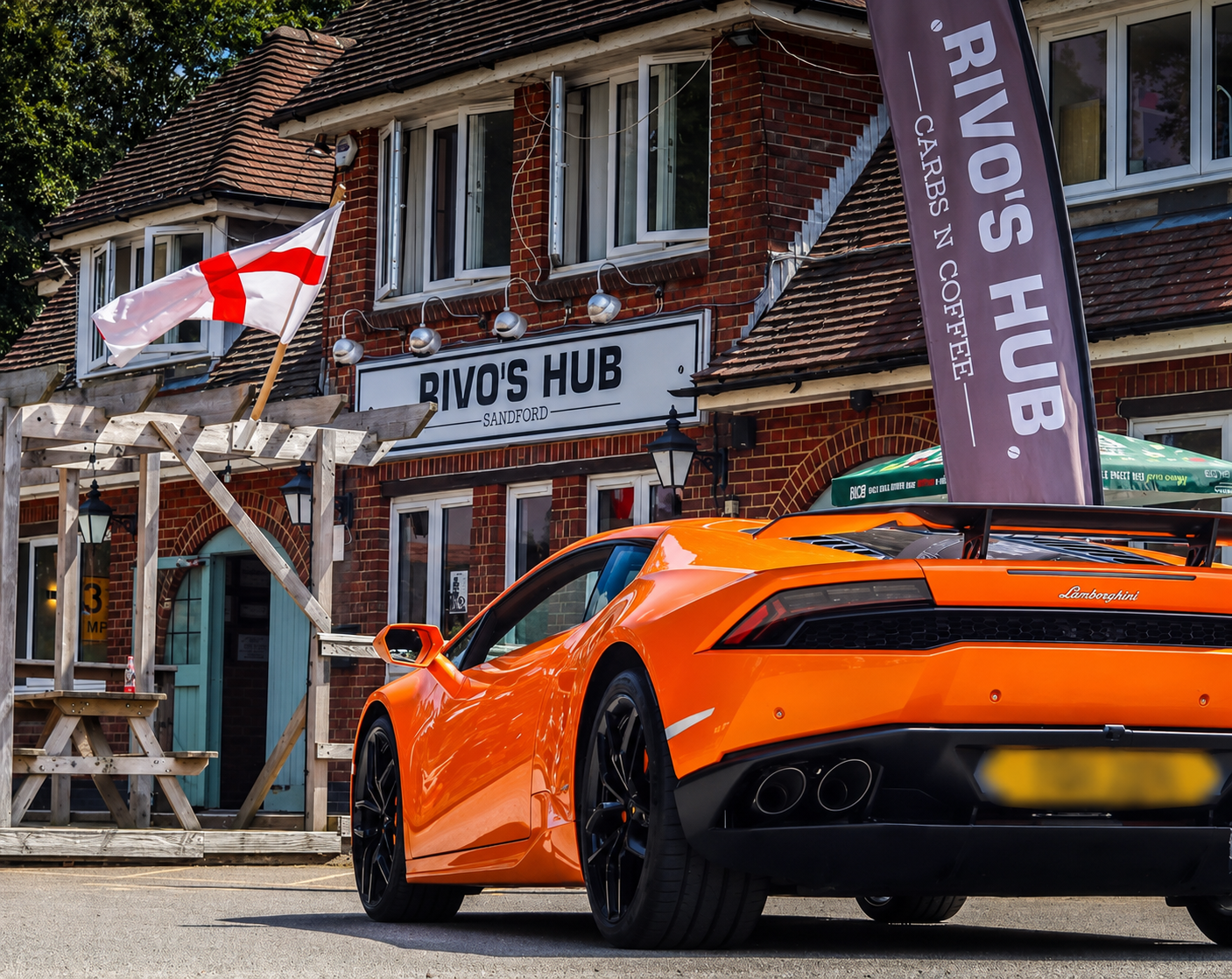 Orange Lamborghini Huracan hire Dorset outside venue, rear view